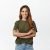 Portrait of confident adult woman in green t-shirt, standing with arms crossed on chest and self-assured motivated smile, looking at camera, standing against white background.